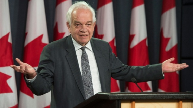 Immigration Minister John McCallum responds to a question while speaking in Ottawa